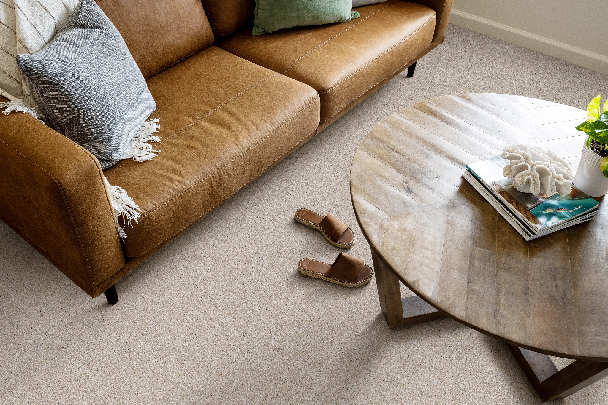 livingroom cozy leather couch round coffee table slippers on floor